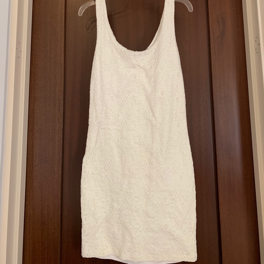 White bodycon dress with floral lace detail